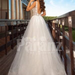 Sleeveless white lace work soft tulle wedding gown back side view