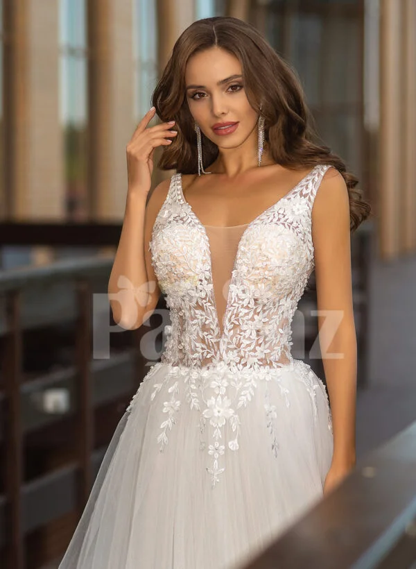 Sleeveless white lace work soft tulle wedding gown close view