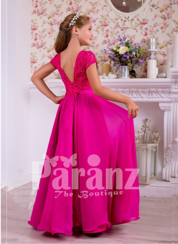 Soft and lightweight rich satin skirt and delicate lacework bodice party gown in fuchsia pink back side view