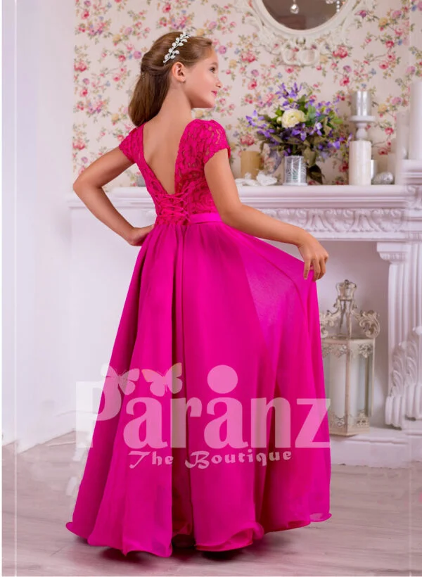 Soft and lightweight rich satin skirt and delicate lacework bodice party gown in fuchsia pink back side view