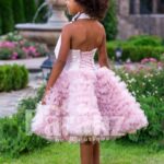 Soft petal pink tea length cloud skirt baby party dress with rich satin off-shoulder bodice side view