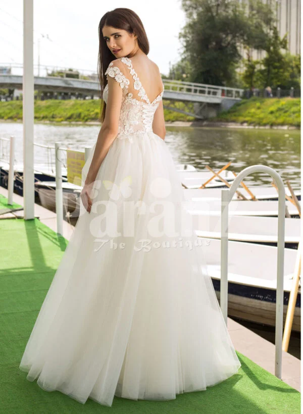 Women’s beautiful lacy floral bodice tulle skirt wedding gown in white back side view