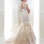 Women’s beautiful mermaid style tulle skirt wedding gown in beige back side view