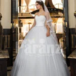 Women’s beautiful off-shoulder pearl white tulle wedding gown with floral bodice