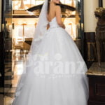 Women’s beautiful off-shoulder pearl white tulle wedding gown with floral bodice back side view