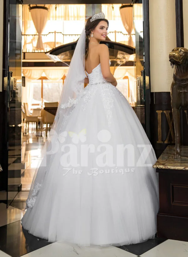 Women’s beautiful off-shoulder pearl white tulle wedding gown with floral bodice back side view