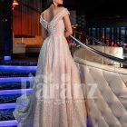 Women’s beautiful off-shoulder side slit party gown with off-shoulder bodice in beige back side view