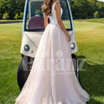 Women’s beautiful power pink-white wedding tulle gown with criss-cross lock back back side view