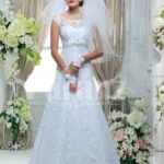 Women’s elegant floor length sleeveless white satin gown with all over white lace work