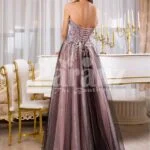 Women’s elegant off-shoulder evening gown with long tulle skirt and rich appliquéd bodice back side view