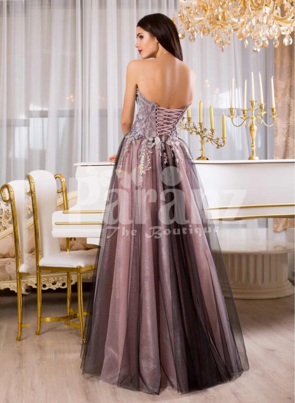Women’s elegant off-shoulder evening gown with long tulle skirt and rich appliquéd bodice back side view