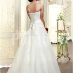 Women’s elegant off-shoulder style wedding gown with flared and high volume tulle skirt back side view