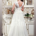 Women’s elegant pearl white floor length wedding gown with super lacy bodice and tulle skirt back side view