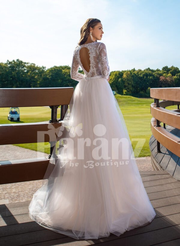 Women’s elegant pearl white tulle wedding gown with royal bodice three quarter sleeves back side view