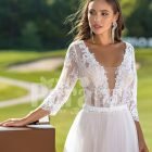 Women’s elegant pearl white tulle wedding gown with royal bodice three quarter sleeves close view