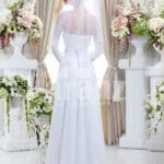 Women’s elegant tulle skirt wedding gown with royal rhinestone studded off-shoulder bodice back side view