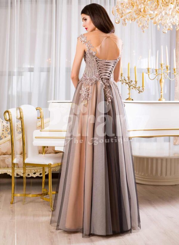 Women’s exclusive evening gown with rich royal appliquéd bodice with floor length tulle skirt back side view