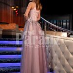 Women’s exclusive mauve evening gown with royal appliquéd bodice and side slit tulle skirt back side view
