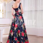 Women’s fancy rich satin floor length blue gown with colorful floral prints all over side view