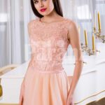 Women’s floor length tulle skirt evening gown with appliquéd bodice in peach hue