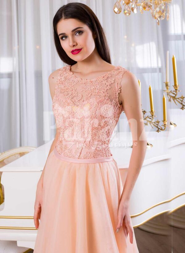 Women’s floor length tulle skirt evening gown with appliquéd bodice in peach hue