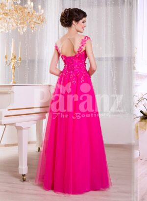 Women’s fuchsia elegant evening gown with long tulle skirt and lace appliquéd bodice back side view