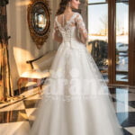 Women’s full lacy sleeves high volume wedding tulle gown with royal bodice back side view