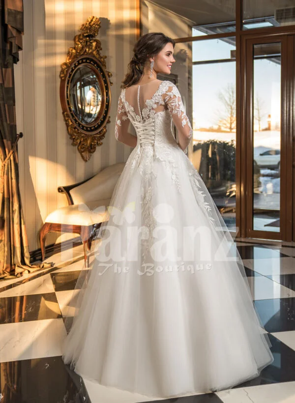 Women’s full lacy sleeves high volume wedding tulle gown with royal bodice back side view