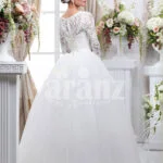 Women’s full sleeve beautiful lacy bodice flared tulle skirt wedding gown in white back side view