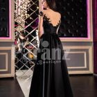 Women’s glam black rich satin evening party gown with side slit skirt and lacy bodice back side view