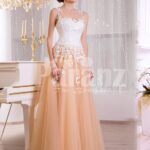 Women’s glam evening gown with peachy orange flared tulle skirt and appliquéd white bodice