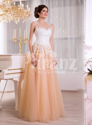 Women’s glam evening gown with peachy orange flared tulle skirt and appliquéd white bodice