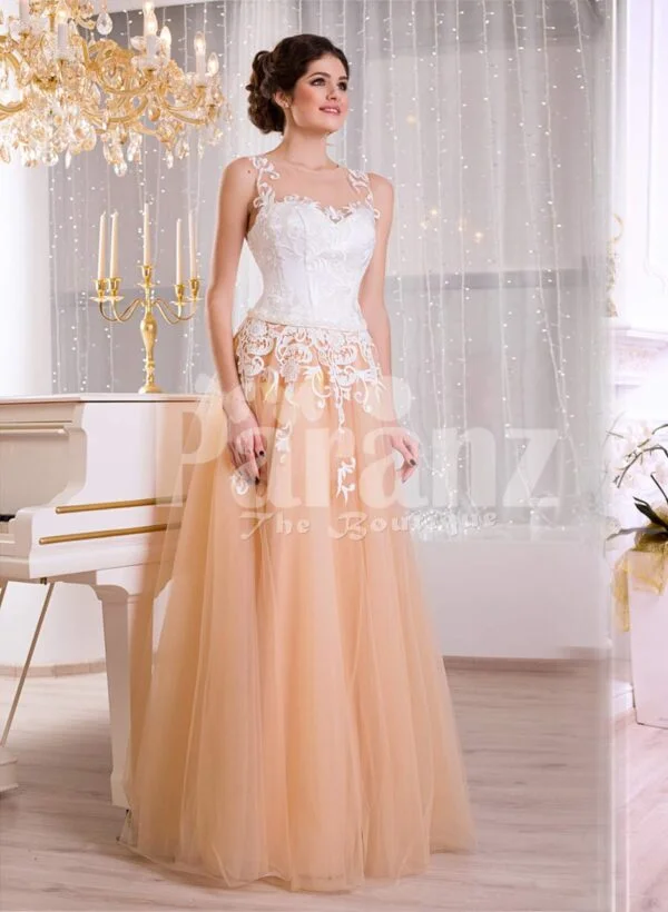 Women’s glam evening gown with peachy orange flared tulle skirt and appliquéd white bodice