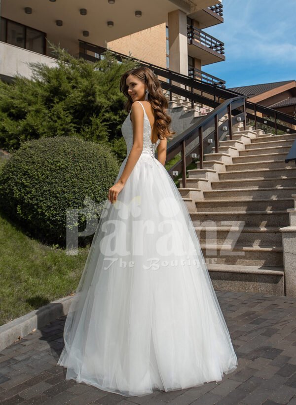 Women’s glam white sleeveless wedding tulle gown with royal bodice back side view