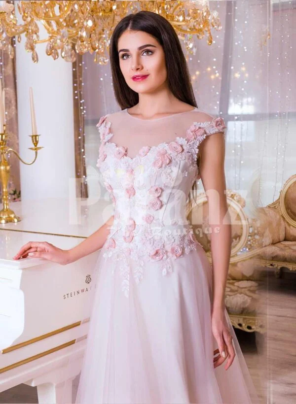 Women’s light pink evening gown with long tulle skirt and pink flower appliquéd bodice