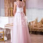 Women’s light pink evening gown with long tulle skirt and pink flower appliquéd bodice back side view