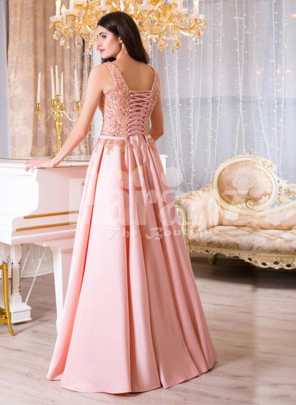 Women’s long evening glam gown with royal rhinestone bodice in peach hue back side view