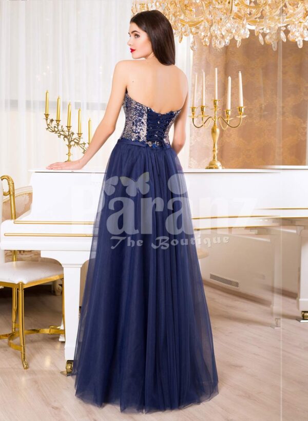 Women’s off-shoulder evening gown with glitz sequin bodice and long tulle skirt in Navy back side view