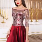 Women’s off-shoulder evening gown with silver appliqués and satin maroon skirt