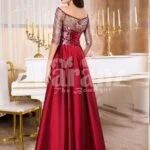 Women’s off-shoulder evening gown with silver appliqués and satin maroon skirt back side view