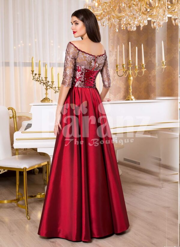 Women’s off-shoulder evening gown with silver appliqués and satin maroon skirt back side view
