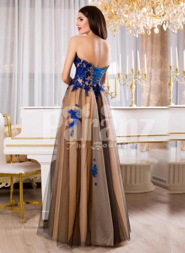 Women’s off-shoulder long tulle evening gown with bright blue floral appliquéd bodice back side view