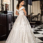 Women’s off-shoulder super stylish rich satin flared wedding gown with tulle skirt underneath back side view