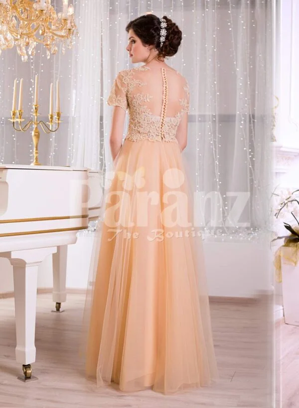 Women’s peachy orange short sleeve evening gown with long and soft tulle skirt back side view