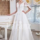 Women’s rich satin floor length white wedding gown with tulle skirt underneath