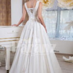 Women’s rich satin floor length white wedding gown with tulle skirt underneath back side view