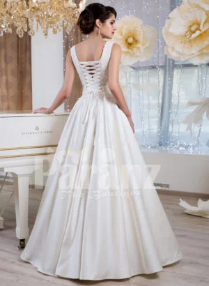 Women’s rich satin floor length white wedding gown with tulle skirt underneath back side view
