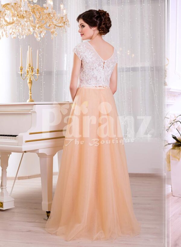 Women’s rich white rhinestone work bodice elegant evening gown with peach tulle skirt back side view