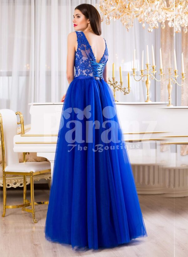 Women’s royal blue elegant evening gown with long tulle skirt and lacy bodice back side view