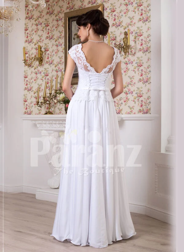 Women’s simple and elegant all white floor length lacy bodice wedding gown back side view